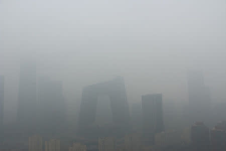 Buildings are seen amid smog on a polluted day where a blue alert is issued, in Beijing, China April 2, 2018. REUTERS/Stringer