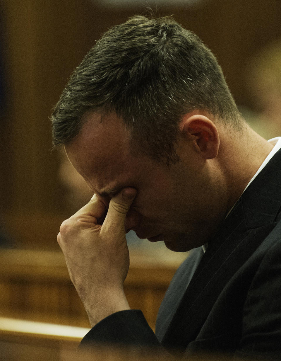 Oscar Pistorius reacts as he listens to forensic evidence being given in court in Pretoria, South Africa, Wednesday, April 16, 2014. Pistorius is charged with the murder of his girlfriend, Reeva Steenkamp, on Valentines Day in 2013. (AP Photo/Gianluigi Guercia, Pool)