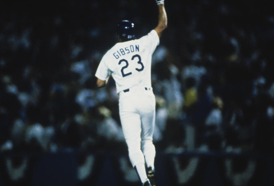 The Dodgers’ Kirk Gibson gestures to the crowd after hitting a home run against the Athletics during the World Series at Dodger Stadium in 1988. (Getty Images)