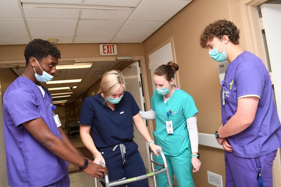 AHEC students Anthony Ugokwe (far left) and Joshua Decker (far right) spend a day in the Rapides Regional Medical Center Rehab Department learning from Bailey Hagan, rehab tech, and Courtney Berry, physical therapist.