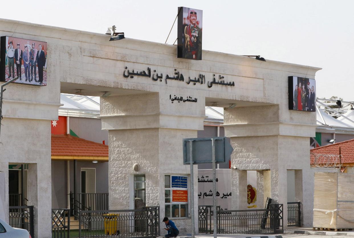 A boy sits in front of the main entrance of the Prince Hashem bin Hussein field hospital, Jordan’s first Covid-19 field hospital, in the city of Zarqa,  east of the capital Amman. (Photo by KHALIL MAZRAAWI/afp/AFP via Getty Images) (afp/AFP via Getty Images)