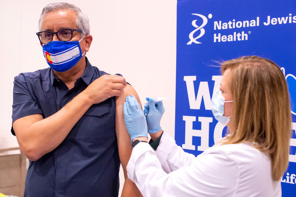 Image: Dr John Torres receives a Covid-19 vaccination shot (Courtesy Dr. John Torres)