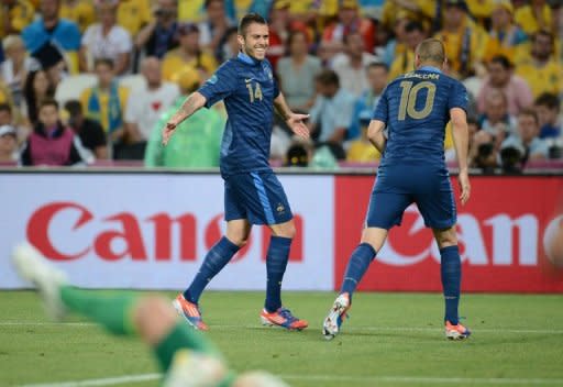 French midfielder Jeremy Menez (L) celebrates with teammate Karim Benzema after scoring during their Euro 2012 Group D match against Ukraine, on June 15, at the Donbass Arena in Donetsk. France won 2-0