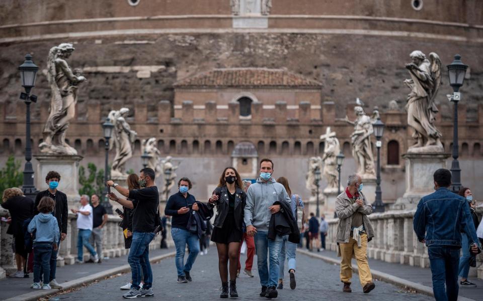 Rome has introduced new measures, making face coverings mandatory in all outdoor spaces - Getty