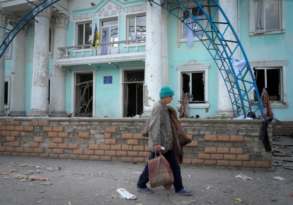 A woman passes by a building destroyed in the Russian shelling in Lysychansk, in the Luhansk region of Ukraine (Efrem Lukatsky/AP/PA) (AP)