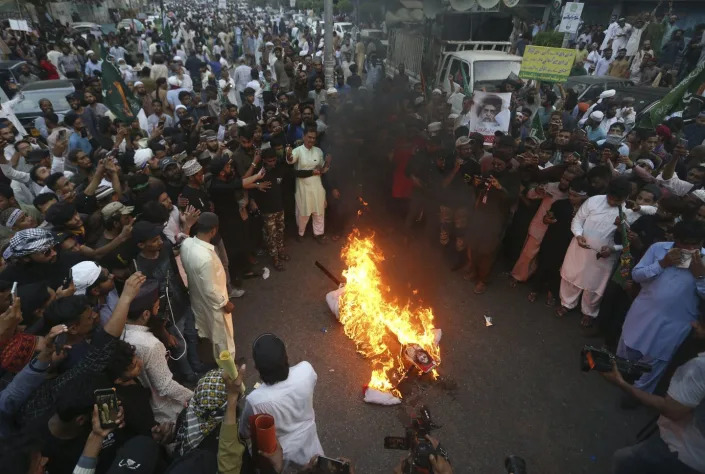 <span class="caption">Supporters of a Pakistani religious group burn an effigy depicting the former spokeswoman of India's ruling party, Nupur Sharma, during a demonstration in Karachi, Pakistan.</span> <span class="attribution"><a class="link " href="https://newsroom.ap.org/detail/PakistanIndiaIslam/cfcff703192e4cfda0ddc017f7060ad8/photo?Query=nupur%20sharma&mediaType=photo&sortBy=&dateRange=Anytime&totalCount=65&currentItemNo=0" rel="nofollow noopener" target="_blank" data-ylk="slk:AP Photo/Fareed Khan">AP Photo/Fareed Khan</a></span>
