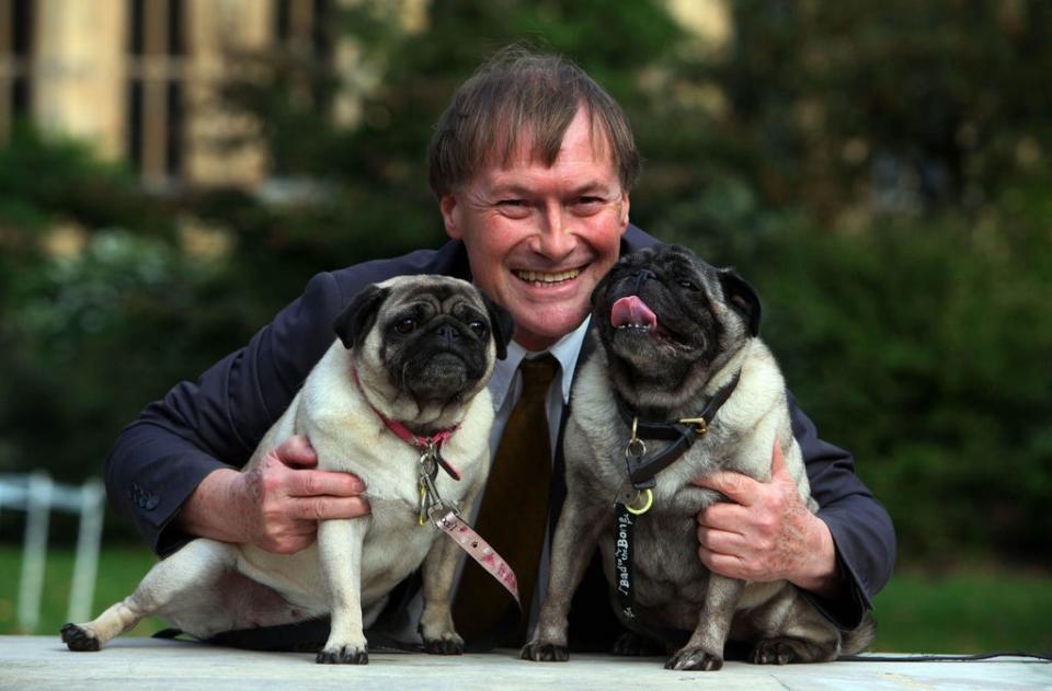 David Amess with his pugs, Lily and Boat at the Westminster Dog of the Year competition in 2013 (PA)