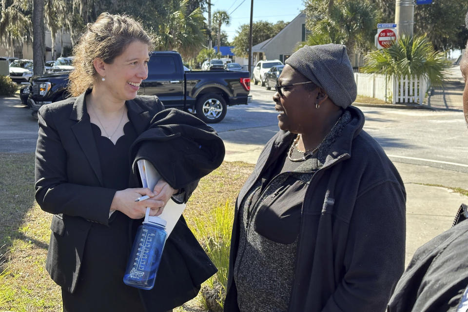 Attorney Miriam Gutman, left, talks with Sharron Grovner outside the McIntosh County courthouse in Darien, Georgia, on Tuesday, Feb. 20, 2024. Gutman is among the attorneys from the Southern Poverty Law Center suing the Georgia county on behalf of residents of Hogg Hummock, a tiny island enclave that's one of the last remaining Gullah-Geechee communities of Black slave descendants in the U.S. South. Hogg Hummock residents are challenging 2023 zoning changes that they fear will lead to property tax increases that force them to sell their families' land. (AP Photo/Russ Bynum)