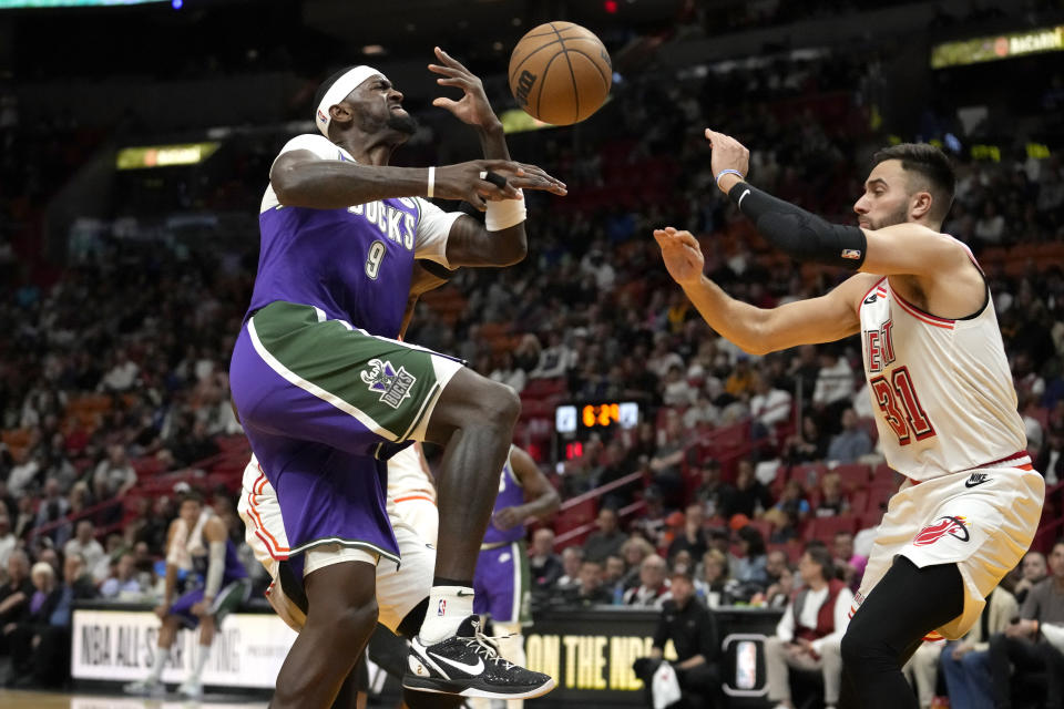 Milwaukee Bucks forward Bobby Portis (9) goes to the basket as Miami Heat guard Max Strus (31) defends during the first half of an NBA basketball game, Saturday, Jan. 14, 2023, in Miami. (AP Photo/Lynne Sladky)