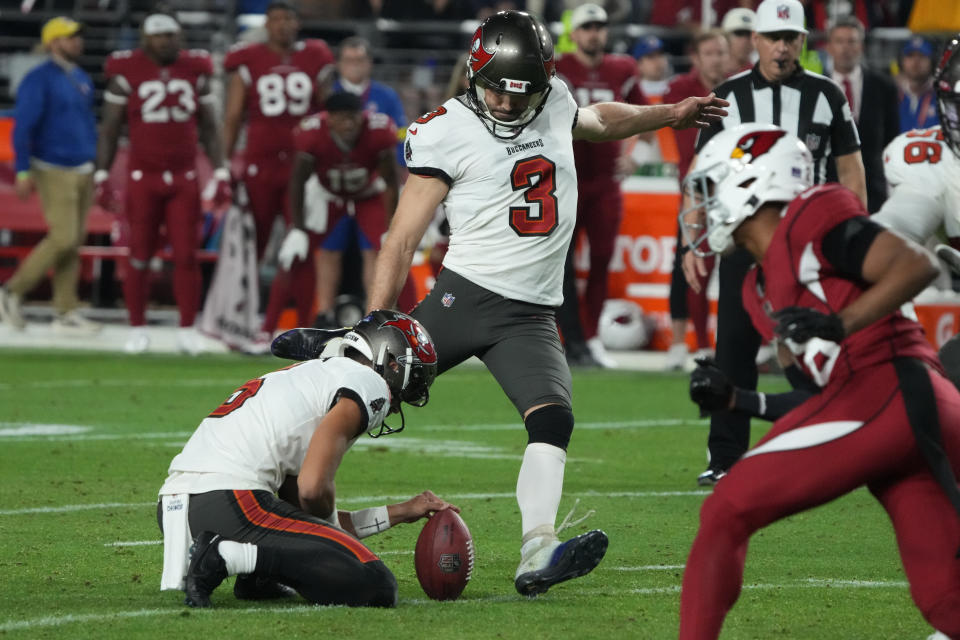 Tampa Bay Buccaneers place kicker Ryan Succop (3) kicks the game-winning field goal against the Arizona Cardinals as punter Jake Camarda holds during the second half of an NFL football game, Sunday, Dec. 25, 2022, in Glendale, Ariz. The Buccaneers defeated the Cardinals 19-16 in overtime. (AP Photo/Rick Scuteri)