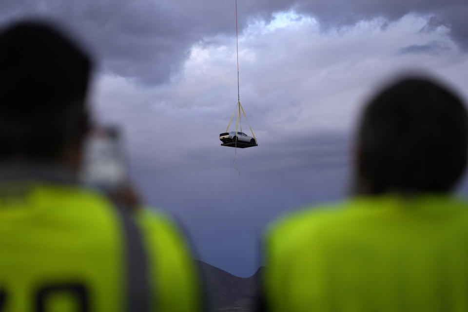 A helicopter transports the 2023 Challenger SRT Demon 170 during an event to unveil the car Monday, March 20, 2023, in Las Vegas. (AP Photo/John Locher)