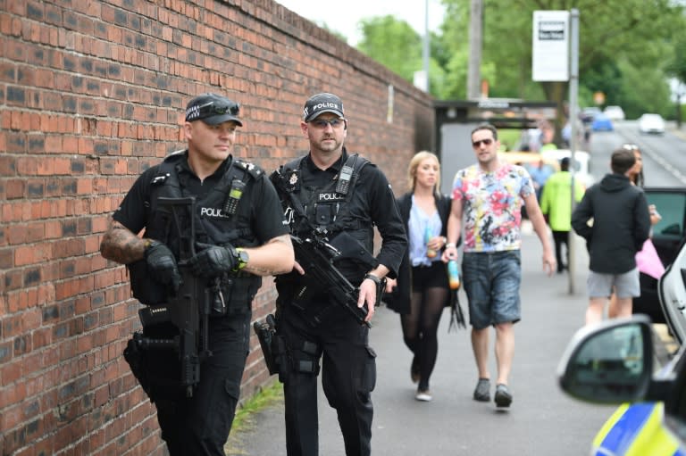 Armed police officers stand guard in Manchester, northwest England, on May 27, 2017