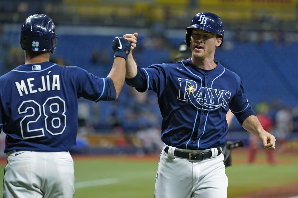 Tampa Bay Rays' Joey Wendle celebrates with Francisco Mejia (28) after Wendle hit a solo home run off Washington Nationals relief pitcher Daniel Hudson during the eighth inning of a baseball game Wednesday, June 9, 2021, in St. Petersburg, Fla. (AP Photo/Chris O'Meara)