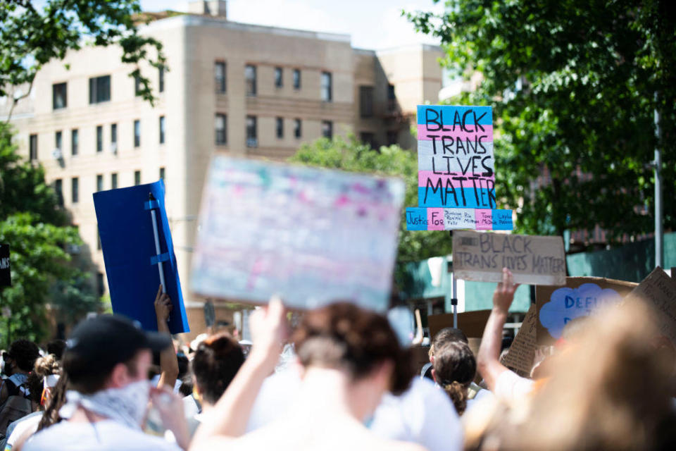 Protestors march with chants, flags, sign and white clothing in support of Black Trans Lives Matter on June 14, 2020. / Credit: Michael Noble Jr. / Getty Images