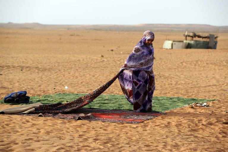 A Sahrawi refugee stands on a rug at the Sahrawi refugee camp of Dakhla, 170 kms to the southeast of the Algerian city of Tindouf, in the disputed territory of Western Sahara, on July 8, 2016