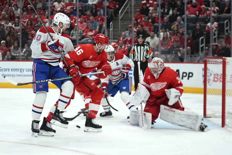 Detroit Red Wings goaltender Alex Lyon (34) deflects a shot as Jeff Petry (46) defends Montreal Canadiens right wing Joel Armia (40) in the first period of an NHL hockey game Monday, April 15, 2024, in Detroit. (AP Photo/Paul Sancya)