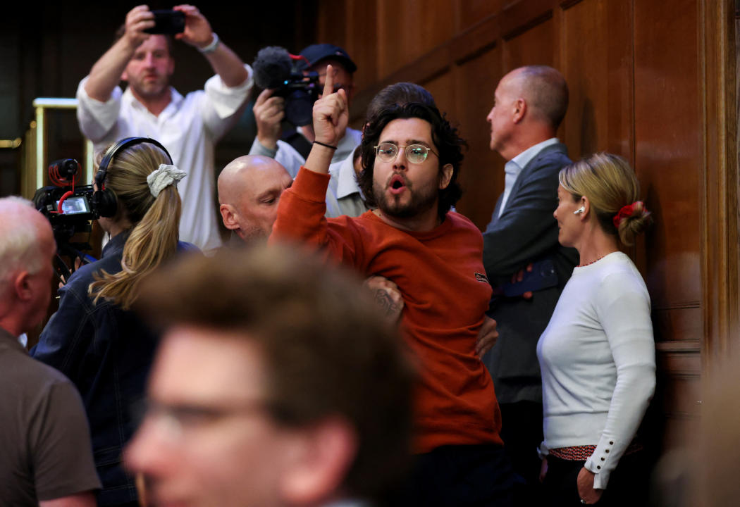 A heckler is escorted out as Britain's Reform UK Party Leader Nigel Farage speaks to the media, in London, Britain July 5, 2024. REUTERS/Belinda Jiao