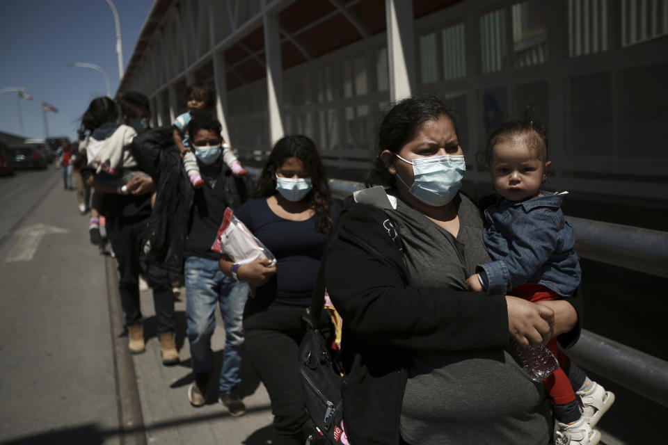 Migrants deported from the U.S. walk into Ciudad Juarez, Mexico, Tuesday, March 23, 2021. Mexico announced that U.S. advisers on border and immigration issues will meet with Mexican officials on Tuesday to discuss migration and development in Central America, as a surge of migrants has hit the U.S. southern border. (AP Photo/Christian Chavez)