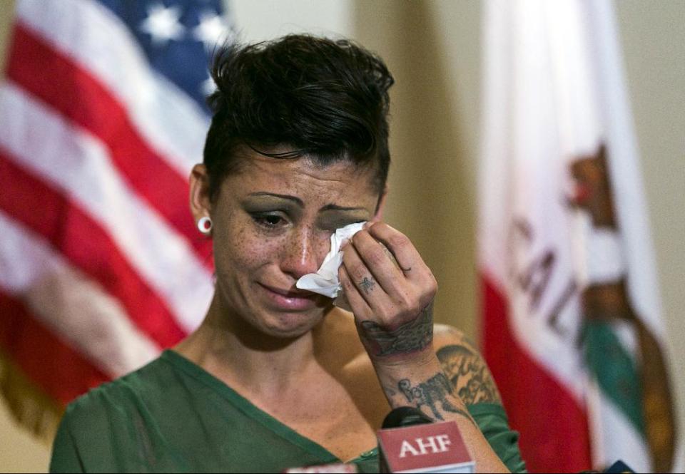 Cameron Bay, an adult film performer who became infected with HIV while working in the industry in August 2013, cries as she speaks out about her treatment by the porn industry during a news conference sponsored by the AIDS Healthcare Foundation at its Public Health Division building in Los Angeles on Wednesday, Sept. 18, 2013. Industry officials say the recent infections have not been tracked back to film sets and most likely occurred through the actors' private lives. (AP Photo/Damian Dovarganes)