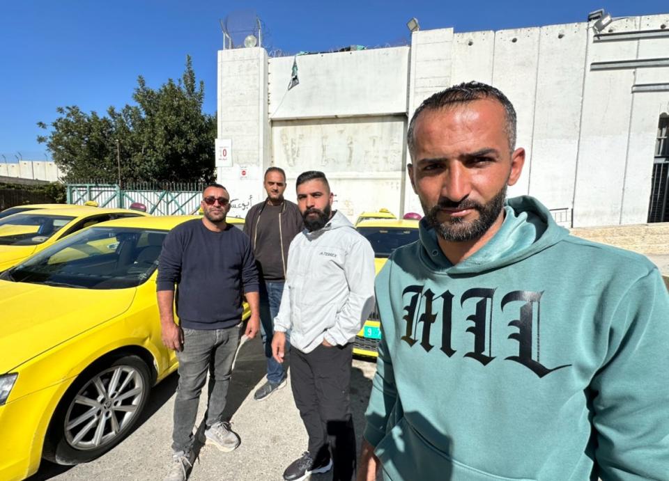 Ahmad Joseph, front, and fellow cab drivers on the Bethlehem side of the border with Israel. Lately, with the collapse of tourism since Oct. 7, there is almost no business for them.