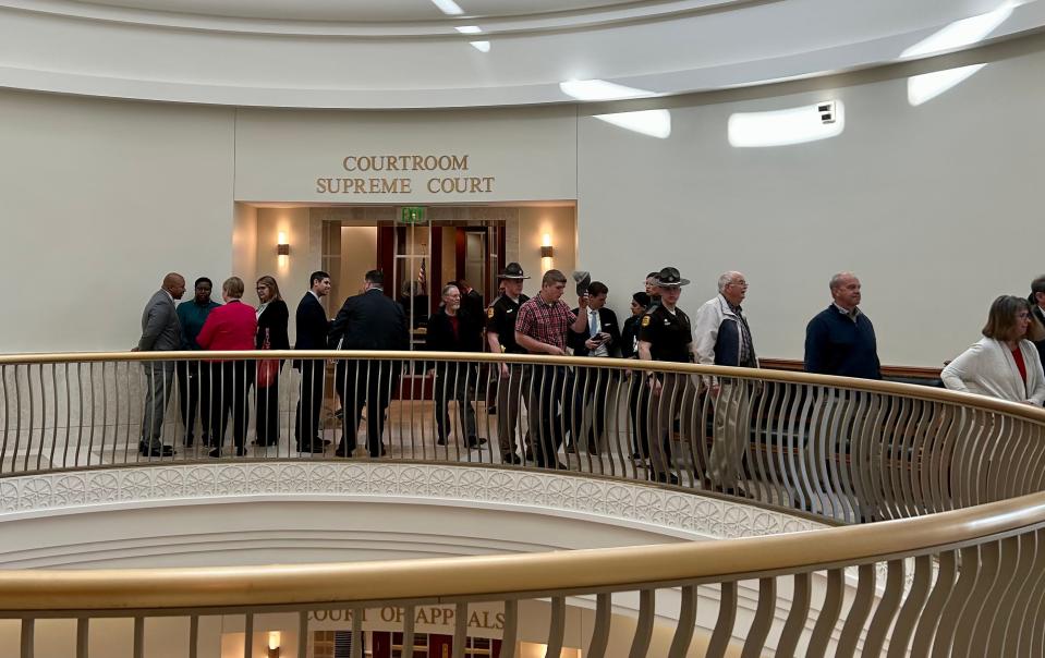 Onlookers file out of the Iowa Supreme Court after arguments over a law that would ban most abortions after six weeks of pregnancy.