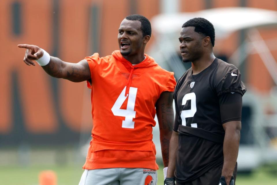 Browns quarterback Deshaun Watson (4) and wide receiver Amari Cooper (2) talk during drills June 6 in Berea.