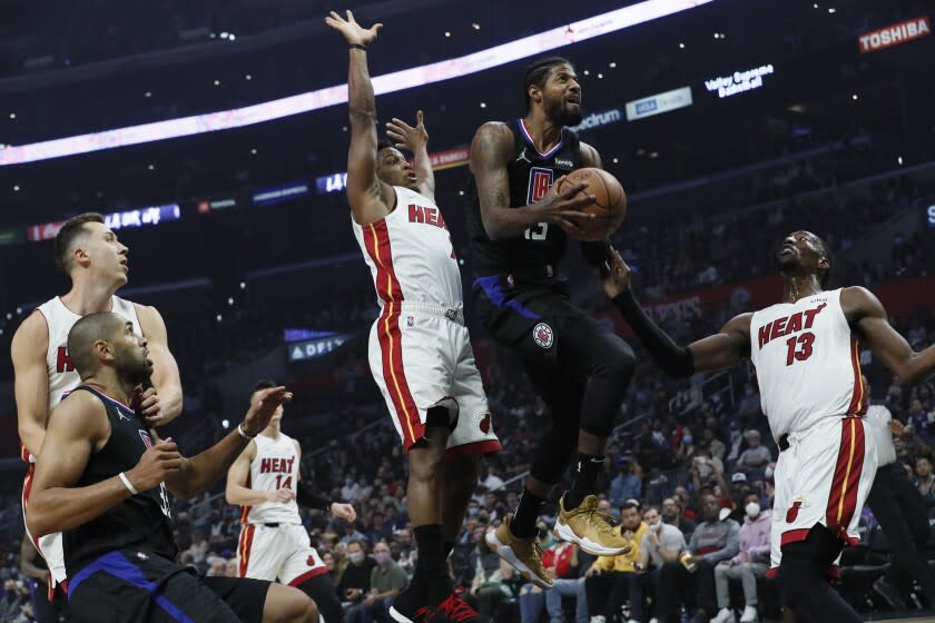 Los Angeles, CA, Thursday, November 11, 2021 - LA Clippers guard Paul George (13) drives past Miami Heat guard Kyle Lowry (7) during first quarter action at Staples Center (Robert Gauthier/Los Angeles Times)