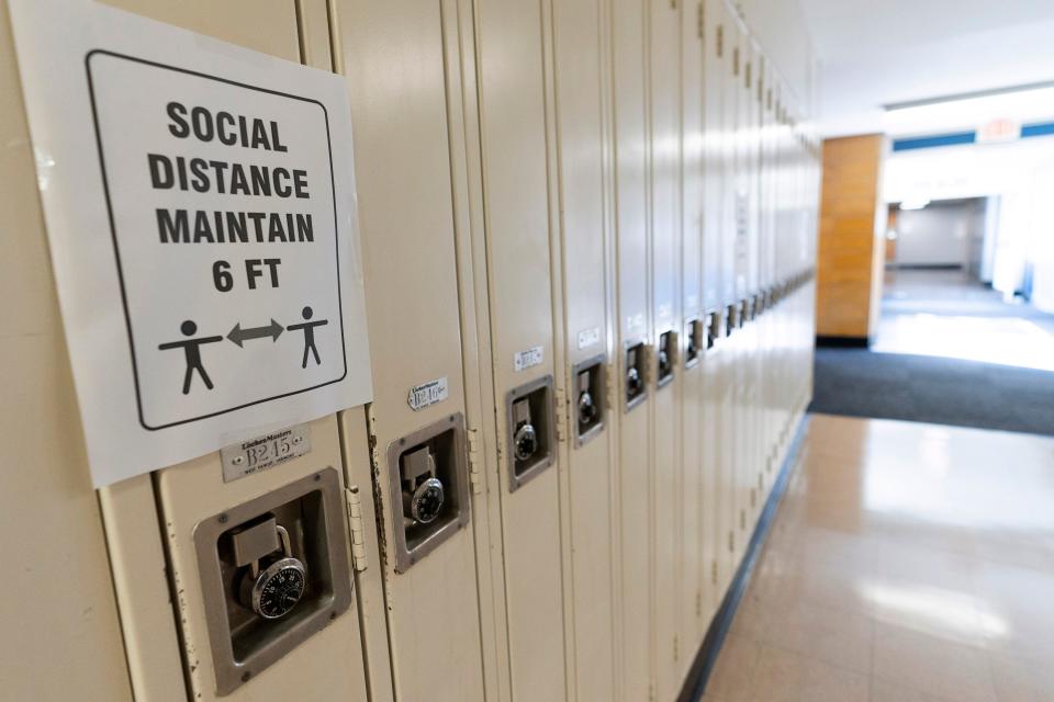 A sign that reads "Social Distance Maintain 6 ft" is posted on student lockers at a school in Baldwin, N.Y., on Aug. 28, 2020.