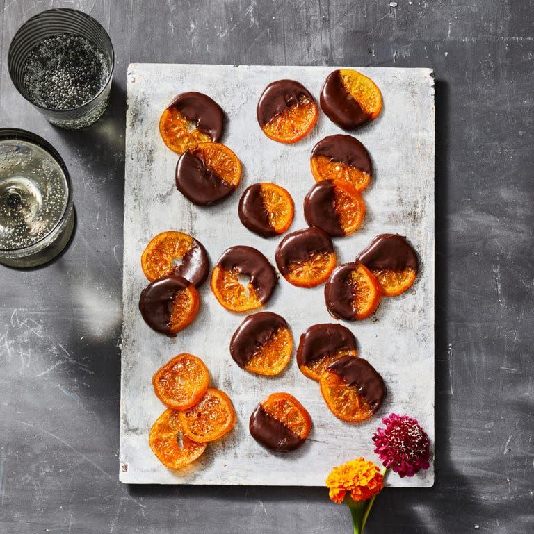 <p>For a sweet and seasonal appetizer, dip some dried clementines in creamy chocolate ganache.</p><p>Get the <strong><a href="https://www.goodhousekeeping.com/food-recipes/dessert/a37116518/candied-clementines-recipe/" rel="nofollow noopener" target="_blank" data-ylk="slk:Candied Clementines recipe;elm:context_link;itc:0;sec:content-canvas" class="link ">Candied Clementines recipe</a></strong>. <br></p>