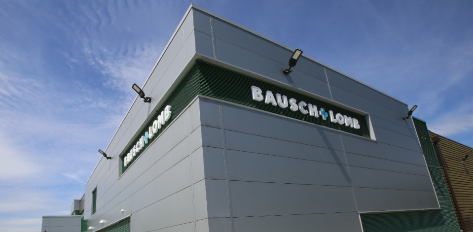 Gray building with green trim and white Bausch & Lomb lettering.