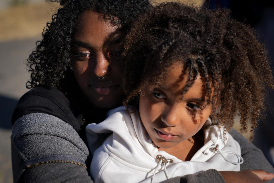 Zohara Grossman-Naples, 15, of Philomath, Ore., left, hugs Charlotte Washington, 8, of East Lansing, Mich., during Camp Be’chol Lashon, a sleepaway camp for Jewish children of color, Saturday, July 29, 2023, in Petaluma, Calif., at Walker Creek Ranch. Grossman-Naples was adopted from Ethiopia. Unlike the other Jewish campers, Charlotte's parents found the sleepaway camp after she told her parents, who are atheists, that she was interested in converting to Judaism. (AP Photo/Jacquelyn Martin)