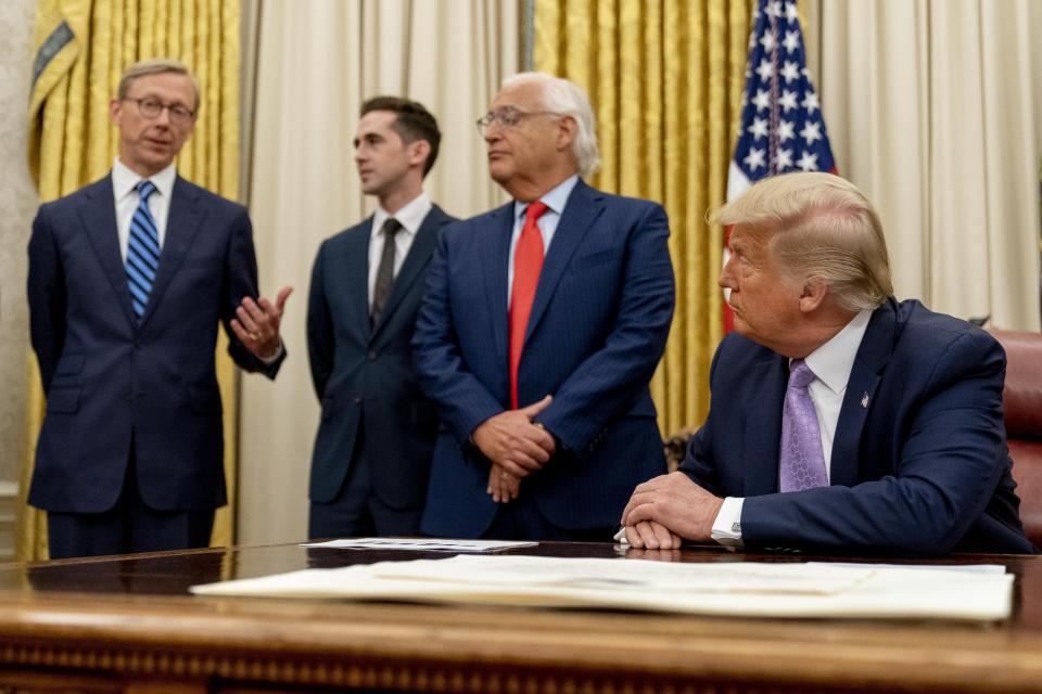 From left, U.S. special envoy for Iran Brian Hook, accompanied by from left, Avraham Berkowitz, Assistant to the President and Special Representative for International Negotiations, U.S. Ambassador to Israel David Friedman, and President Donald Trump, speaks in the Oval Office at the White House, Wednesday, Aug. 12, 2020, in Washington. Trump said on Thursday that the United Arab Emirates and Israel have agreed to establish full diplomatic ties as part of a deal to halt the annexation of occupied land sought by the Palestinians for their future state. (AP Photo/Andrew Harnik)