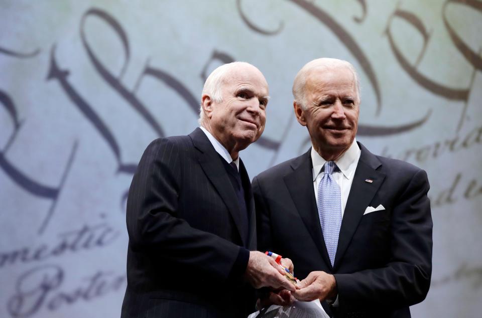 FILE - The late Sen. John McCain, R-Ariz, receives the Liberty Medal from Chair of the National Constitution Center's Board of Trustees, former Vice President Joe Biden, in Philadelphia, on Oct. 16, 2017. McCain's wife Cindy McCain, announced Sept. 22, 2020, she endorses Biden, the Democrat nominee, for president.