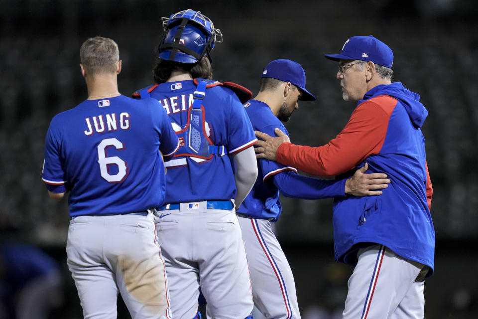 Texas Rangers pitcher Nathan Eovaldi, second from right, is removed by manager Bruce Bochy, right, during the ninth inning of the team's baseball game against the Oakland Athletics in Oakland, Calif., Thursday, May 11, 2023. (AP Photo/Godofredo A. Vásquez)