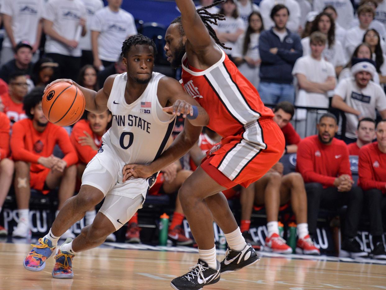 Penn State's Kanye Clary (0) drives the baseline on Ohio State's Bruce Thornton during the first half of an NCAA college basketball game Saturday, Dec. 9, 2023, in State College, Pa. (AP Photo/Gary M. Baranec