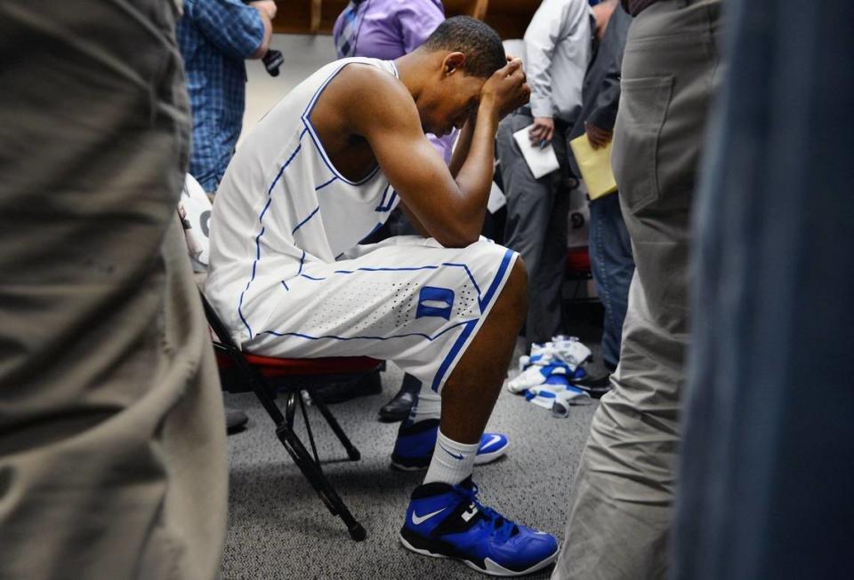 Members of the media mill around Duke forward Rodney Hood (5) in the locker room after the Blue Devils were upset by Mercer 78-71 in their opening game of the NCAA Men’s Basketball Tournament at the PNC Arena in Raleigh, N.C. Friday, March 21, 2014.