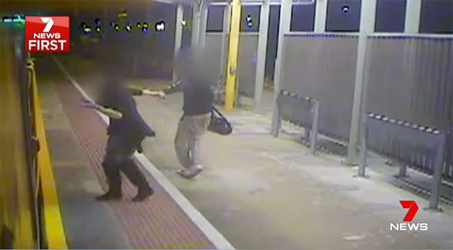 A woman who appears intoxicated tries to hop back on the train. Source: 7 News