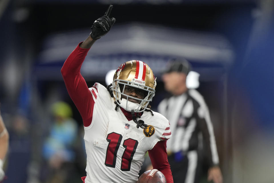 San Francisco 49ers wide receiver Brandon Aiyuk runs back to the sideline after a 28-yard reception for a touchdown during the second half of an NFL football game against the Seattle Seahawks, Thursday, Nov. 23, 2023, in Seattle. (AP Photo/Stephen Brashear)