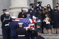 Logan Evans and his sister Abigail Evans, along with their mother Shannon Terranova, watch as the casket of their father, slain U.S. Capitol Police officer William "Billy" Evans, arrives on Capitol Hill in Washington, Tuesday, April 13, 2021. Evans, 41, who served for 18 years on the Capitol Police force, was killed April 2, when a vehicle rammed into him and another officer during an attack at a security barricade, will lie in honor in the Rotunda. (AP Photo/Susan Walsh)