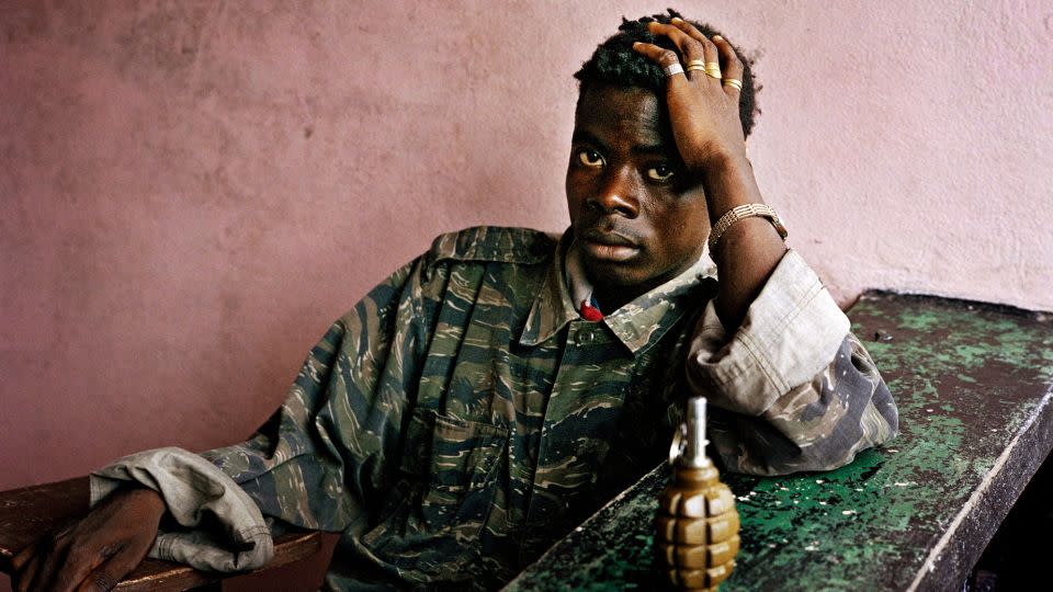 A young rebel fighter and hand grenade, taken in Tubmanberg. Liberia in June 2003. - Tim Hetherington