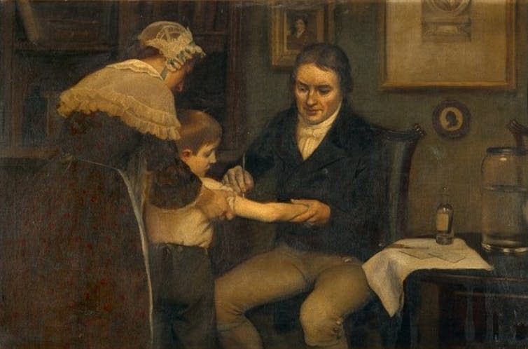 <span class="caption">Edward Jenner performing his first vaccination on James Phipps.</span> <span class="attribution"><a class="link " href="https://commons.wikimedia.org/w/index.php?curid=90129751" rel="nofollow noopener" target="_blank" data-ylk="slk:Ernest Board/Wikimedia Commons;elm:context_link;itc:0;sec:content-canvas">Ernest Board/Wikimedia Commons</a></span>