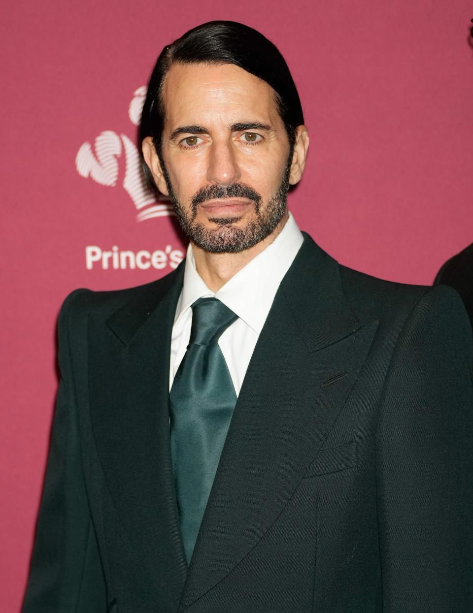 Marc in dark suit with tie at a media event