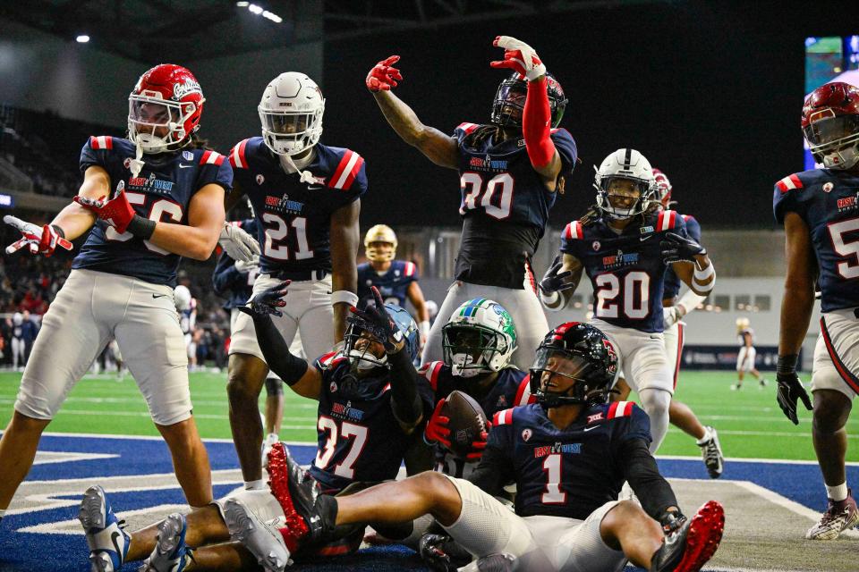 Former Texas cornerback Ryan Watts, second from left, celebrates with his West squad teammates after Jarius Monroe of Tulane intercepted a pass in the East-West Shrine Bowl at the Star in Frisco. Watts had three solo tackles in the game while playing both cornerback and safety.