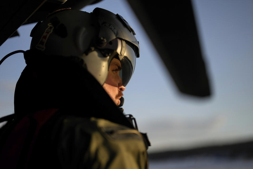 French Chief Petty officer Julien looks on during a flight to join the French navy frigate Normandie in a Norwegian fjord, north of the Arctic circle, for a reconnaissance patrol, Wednesday March 6, 2024. The French frigate is part of a NATO force conducting exercises in the seas, north of Norway, codenamed Steadfast Defender, which are the largest conducted by the 31 nation military alliance since the cold war.(AP Photo/Thibault Camus)