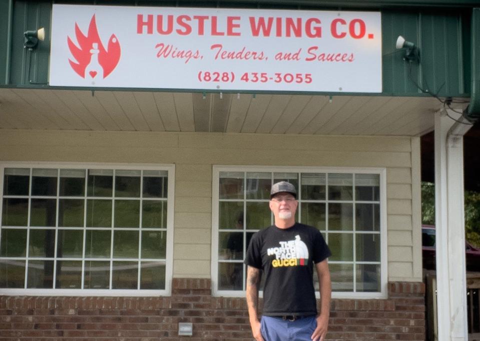Jared Dotson poses in front of his new business, Hustle Wing Company, which is set to open soon in Horse Shoe.