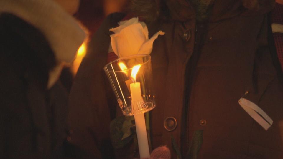 A candle, rose and white ribbon at a vigil on the 30th anniversary of the 1989 École Polytechnique tragedy Friday, Dec. 6, 2019 in Ottawa.