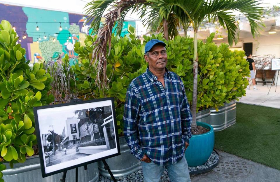 Amarnauth Ramnaraine, 58, stands next to his photo for sale during The Smile Trust’s “Smile Fuh Me” event at the N’Namdi Contemporary Fine Art Gallery in Miami’s Little Haiti neighborhood on Sunday, Dec. 5, 2021.