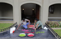 Sri Lankan ethnic Tamil Hindu devotees decorate the entrance to their house in Colombo, Sri Lanka, Friday, Jan. 1, 2021. (AP Photo/Eranga Jayawardena)