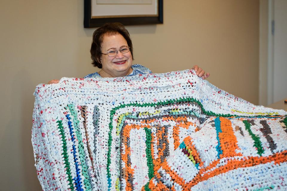 Karen Damerville holds up one of the mats she made out of plastic bags on May 9, 2023 at Grand Living in West Des Moines.
