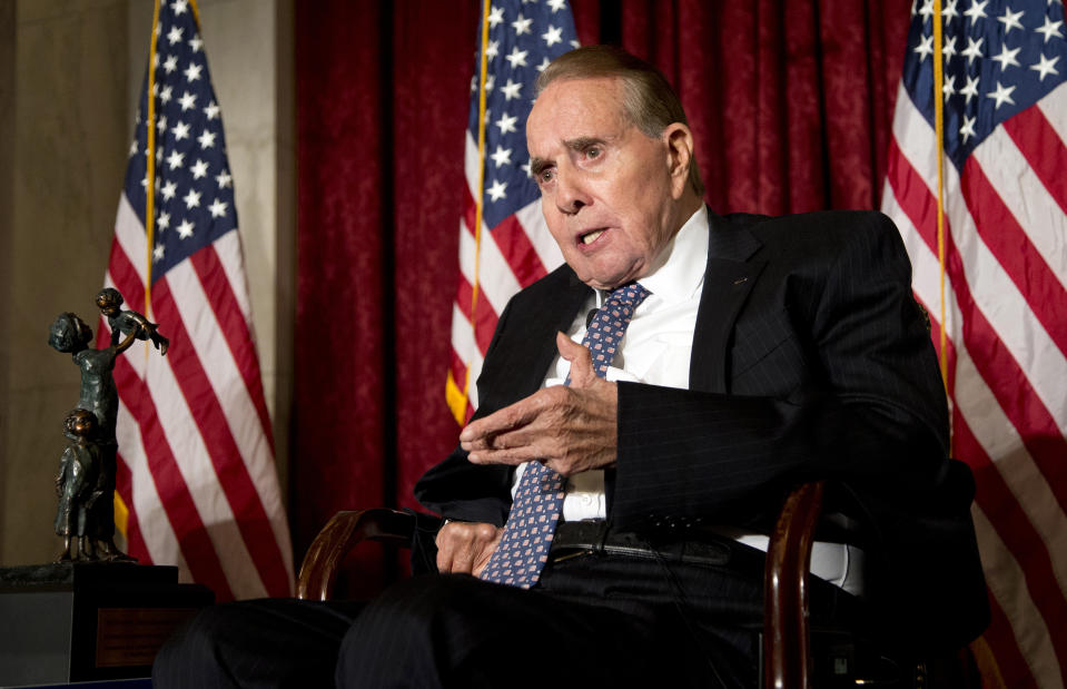 FILE - Former Senate Majority Leader Bob Dole, right, speaks after being presented with the McGovern-Dole Leadership Award by Vice President Joe Biden, to honor his leadership in the fight against hunger, during the 12th Annual George McGovern Leadership Award Ceremony hosted by World Food Program USA, on Capitol Hill in Washington, Wednesday, Dec. 11, 2013. Bob Dole, who overcame disabling war wounds to become a sharp-tongued Senate leader from Kansas, a Republican presidential candidate and then a symbol and celebrant of his dwindling generation of World War II veterans, has died. He was 98. His wife, Elizabeth Dole, posted the announcement Sunday, Dec. 5, 2021, on Twitter. (AP Photo/Manuel Balce Ceneta, File)